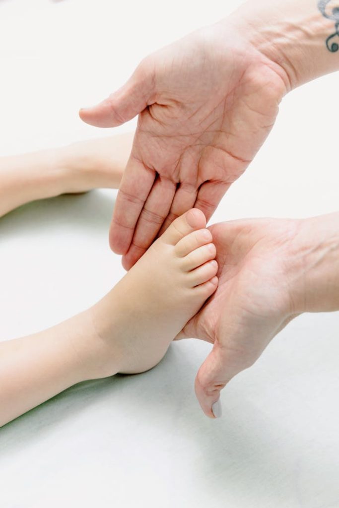 Person Massaging Baby Feet